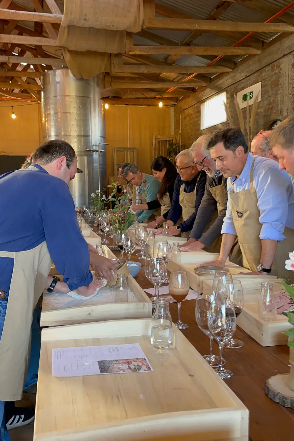 The workshop's long table, with participants kneading and laughing