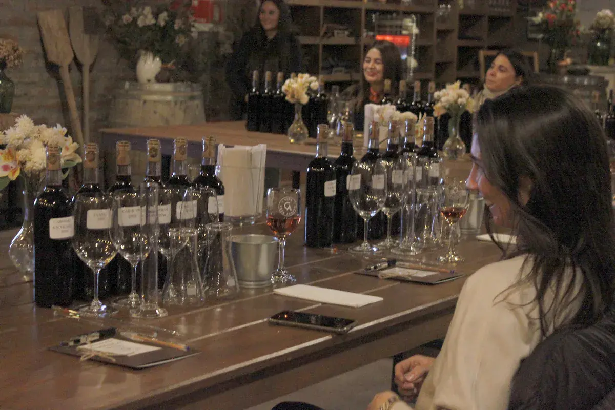 Blending bottles on the table, with participants smiling behind