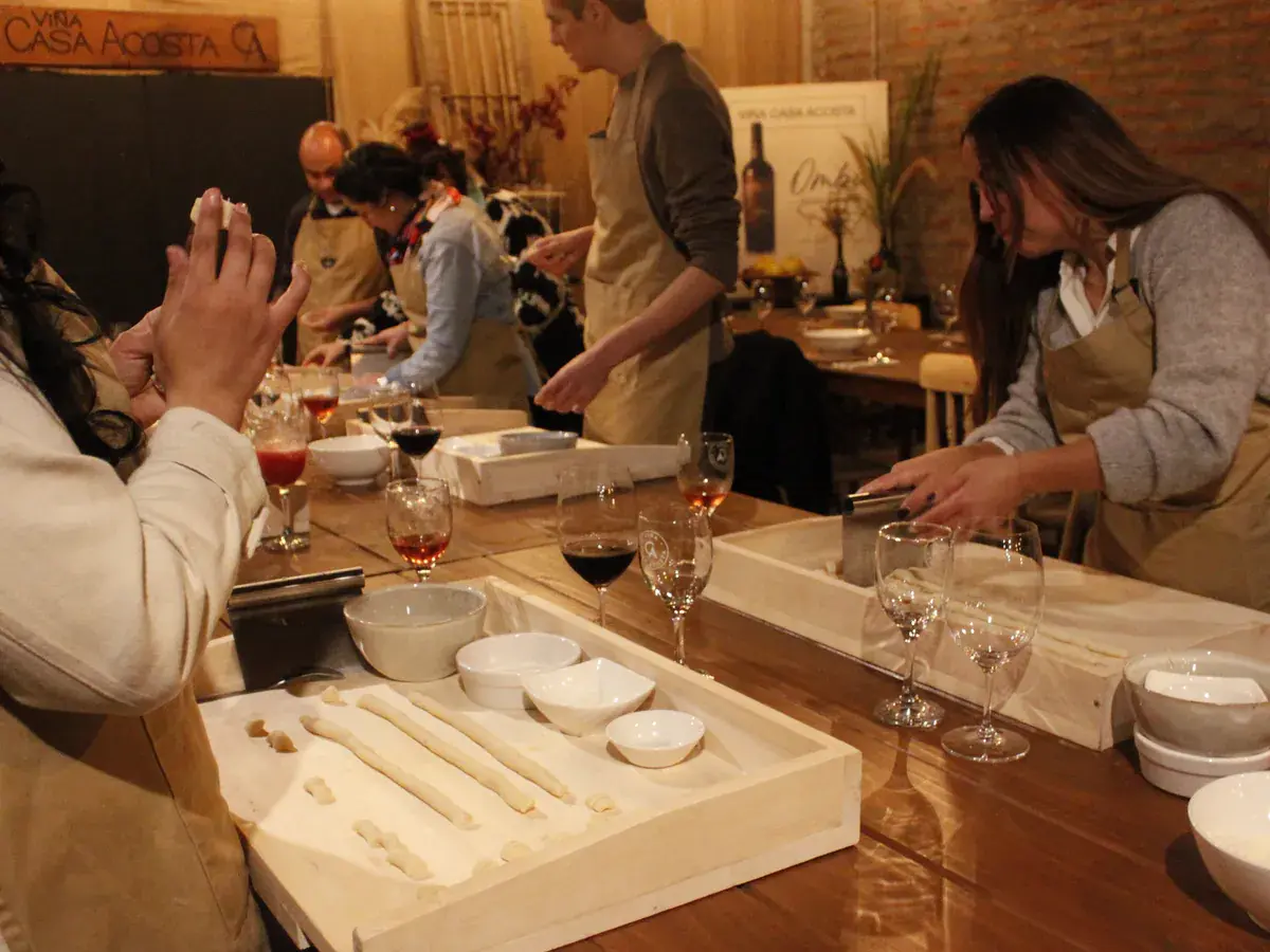 Two participants cut and shape gnocchi from rolls of dough