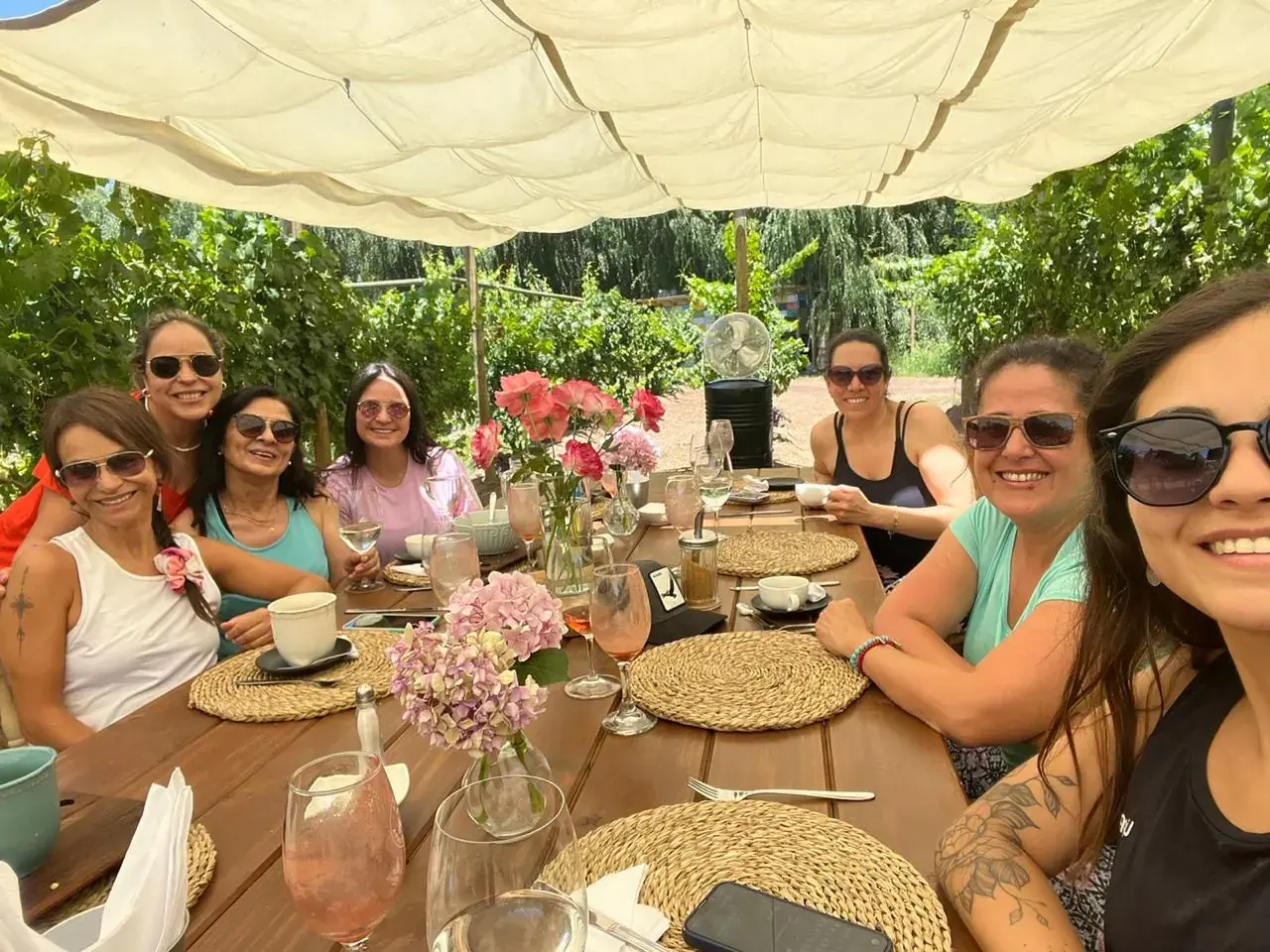 The group smiles around the brunch table after the practice