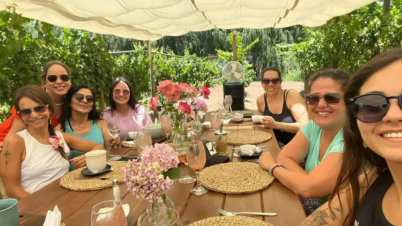 The group smiles around the brunch table after the practice