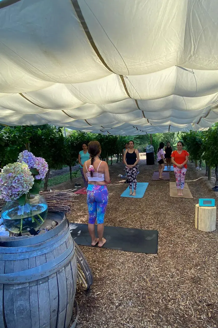 The instructor guides the group beside a barrel with hydrangeas