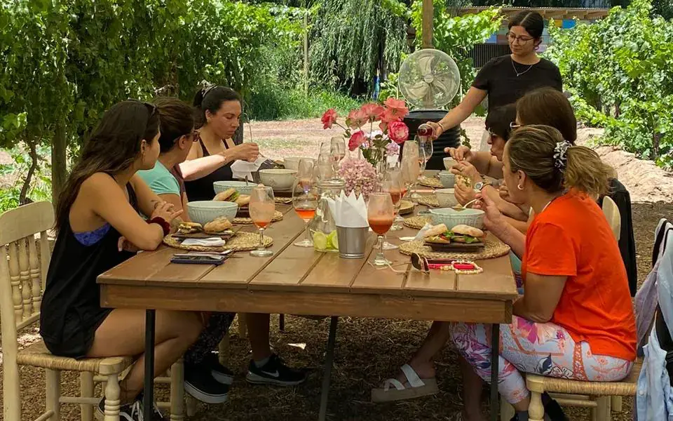 Brunch served at the long table under the canopy, with ciabattas, glasses of infused water and flowers